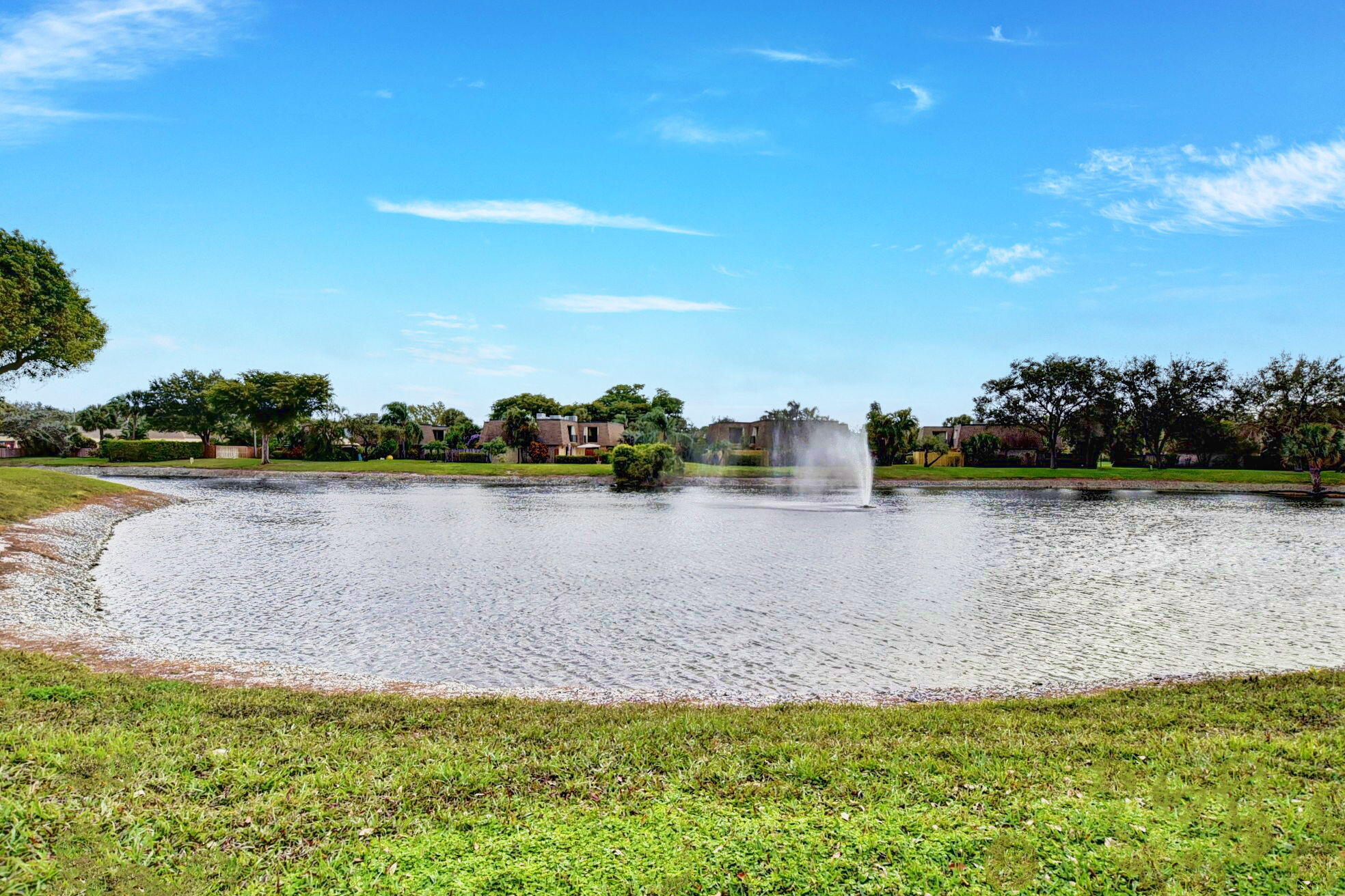 2907 Southwest 22nd Circle, Unit 39D Delray Beach, FL 33445 - Photo 38 of 57 a view of a lake with houses in the background