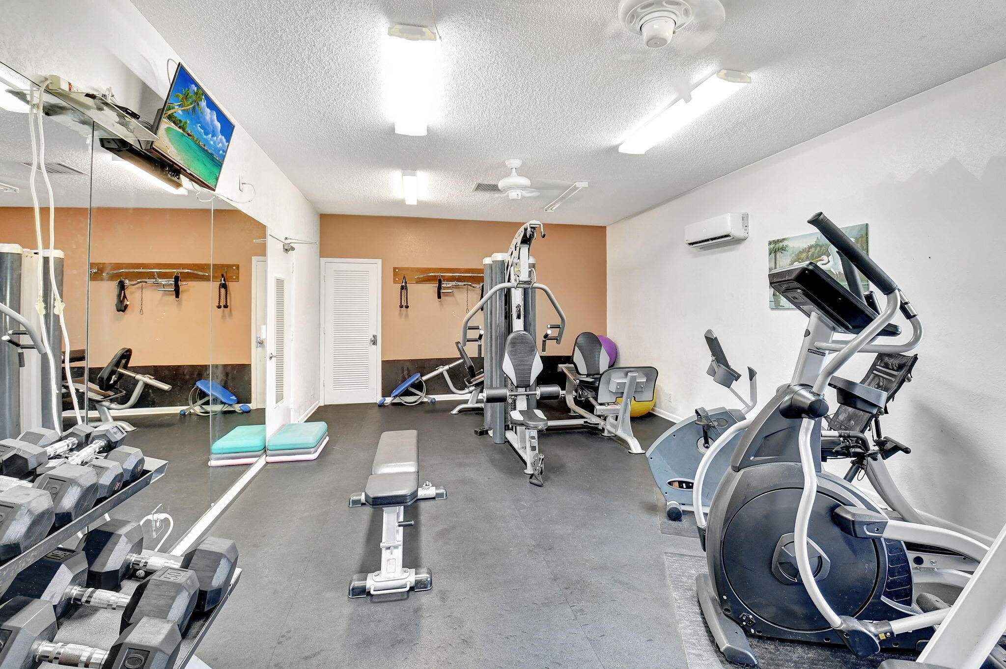 2907 Southwest 22nd Circle, Unit 39D Delray Beach, FL 33445 - Photo 46 of 57 a view of a room with gym equipment
