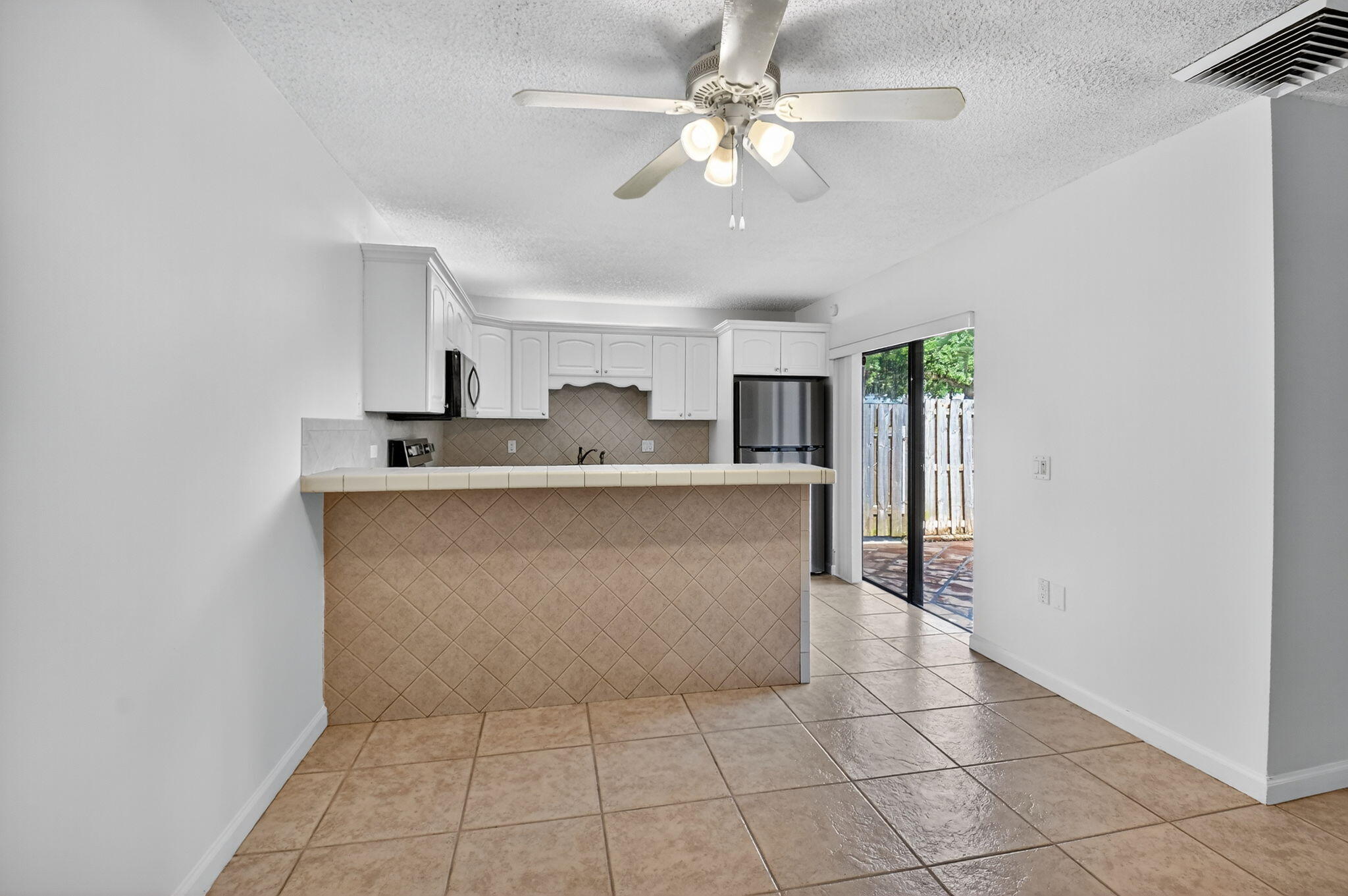 2907 Southwest 22nd Circle, Unit 39D Delray Beach, FL 33445 - Photo 8 of 57 a kitchen with stainless steel appliances a sink a stove top oven a counter top space and cabinets