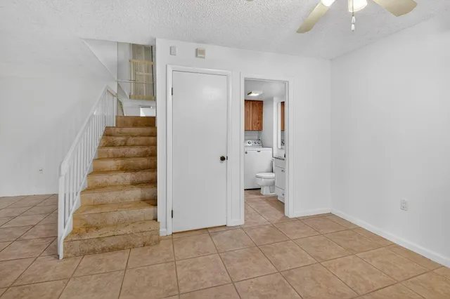 a bathroom with a granite countertop sink toilet and mirror
