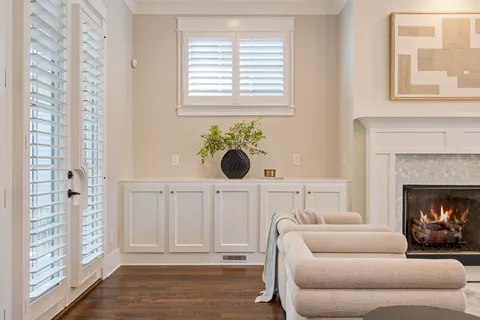 a living room with furniture a chandelier and a large mirror
