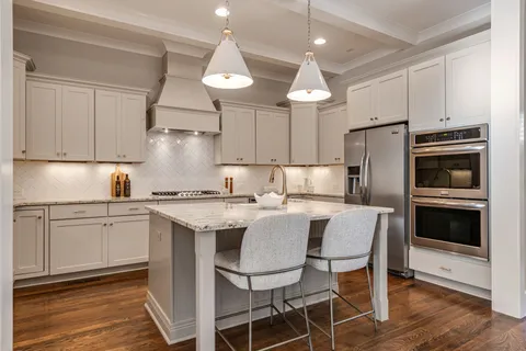 a kitchen with a center island appliances and cabinets
