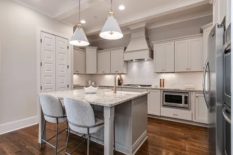 a kitchen with stainless steel appliances granite countertop a stove a refrigerator and a refrigerator