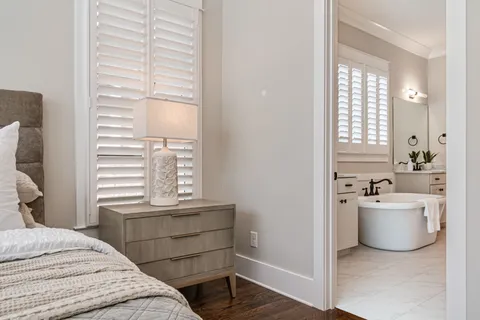 a bathroom with a double vanity sink a mirror and a bathtub