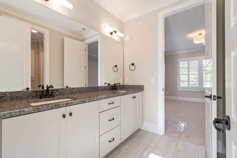 a bathroom with a granite countertop sink a toilet and bathtub