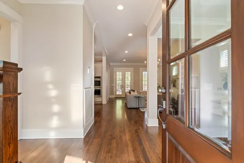 a view of an entryway with wooden floor and a front door
