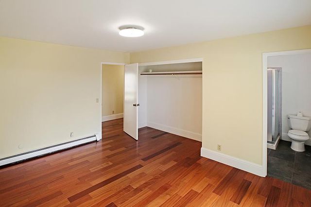 a white toilet sitting next to a shower