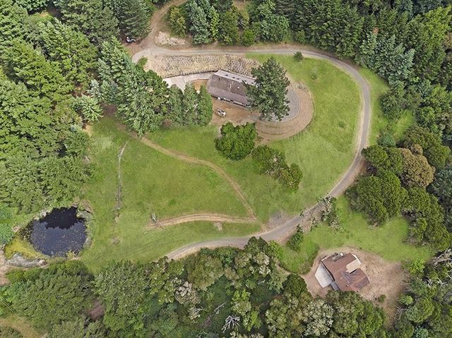an aerial view of a residential houses with outdoor space