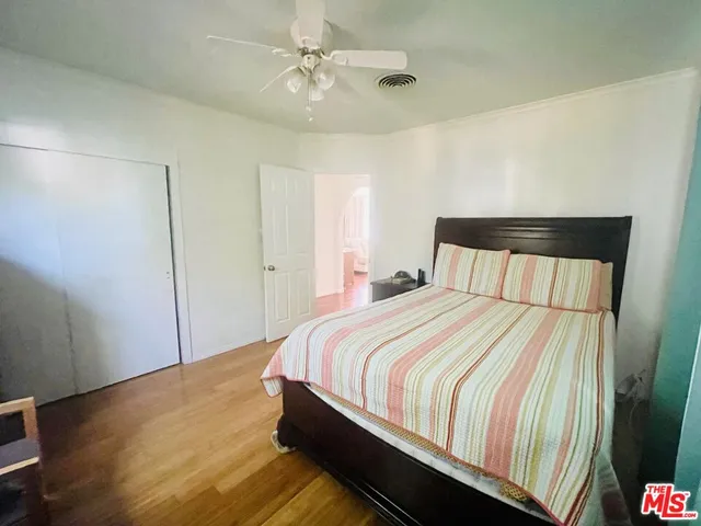 a bedroom with a bed and a dresser