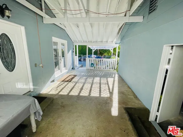 a view of a patio with a table and chairs