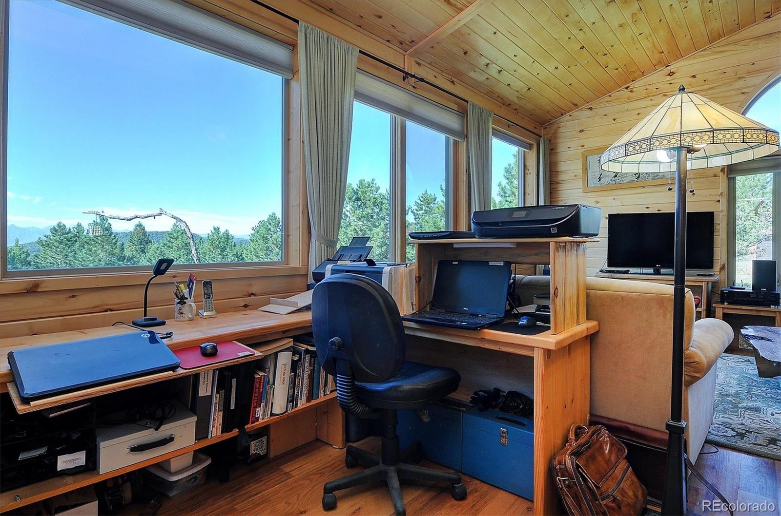 1111 Red Feather Road Cotopaxi, CO 81223 - Photo 14 of 37 a view of a workspace with furniture and a window