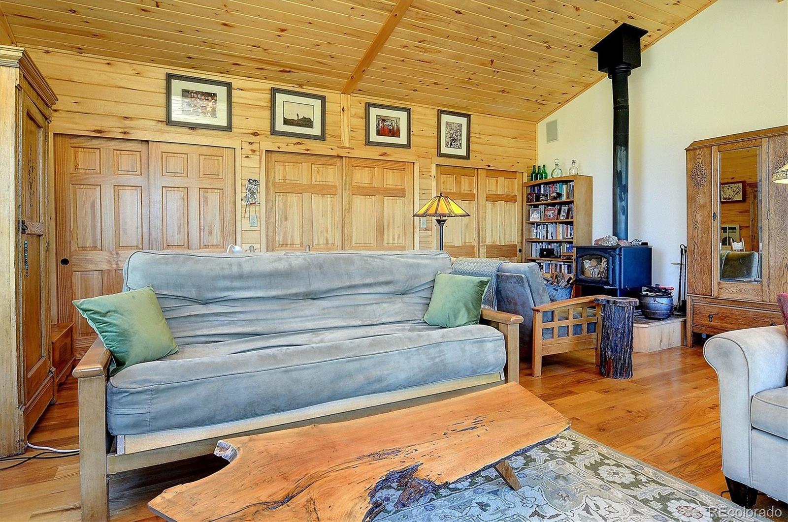 1111 Red Feather Road Cotopaxi, CO 81223 - Photo 15 of 37 a living room with furniture wooden floor and a table