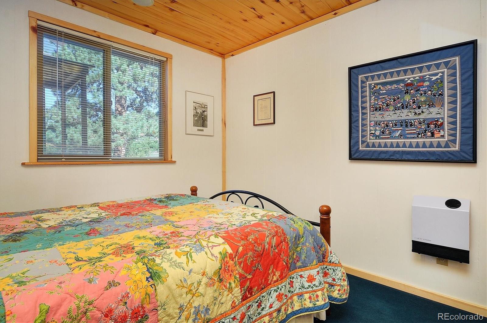1111 Red Feather Road Cotopaxi, CO 81223 - Photo 19 of 37 a bedroom with a bed and a window