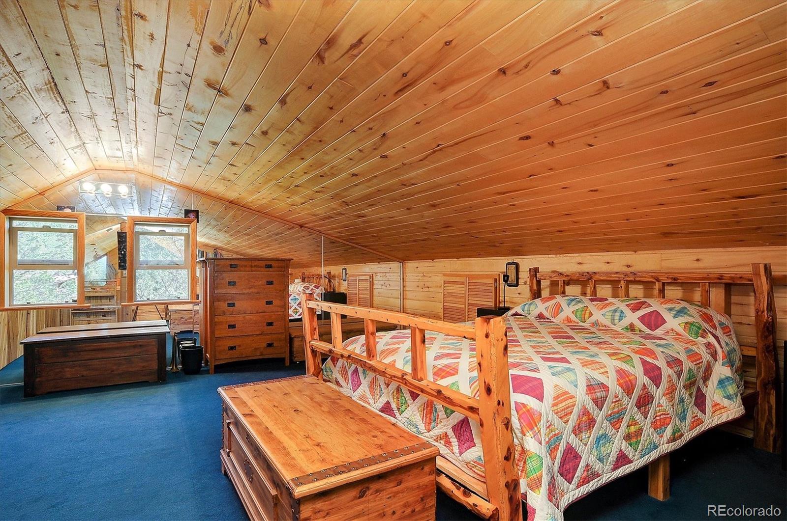 1111 Red Feather Road Cotopaxi, CO 81223 - Photo 21 of 37 a bedroom with furniture and window