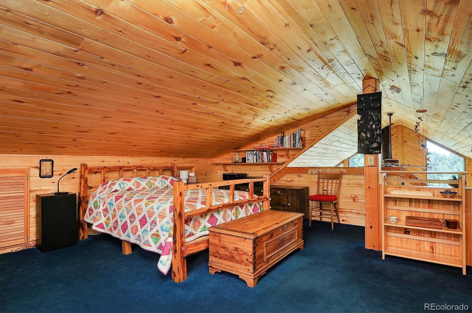 1111 Red Feather Road Cotopaxi, CO 81223 - Photo 22 of 37 a bed sitting in a bedroom next to a window