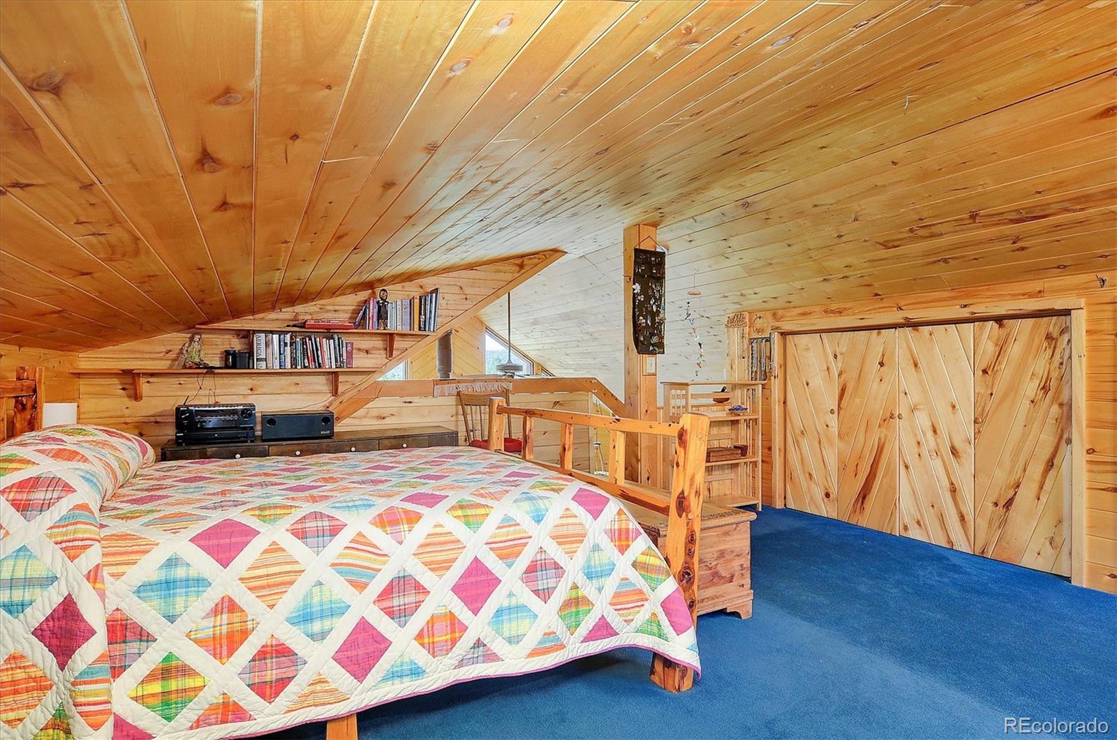 1111 Red Feather Road Cotopaxi, CO 81223 - Photo 23 of 37 a bedroom with furniture and a wooden floor