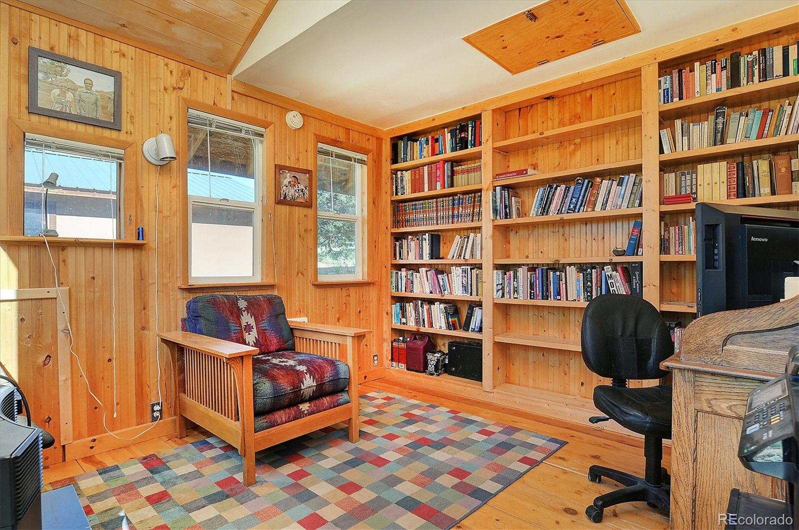 1111 Red Feather Road Cotopaxi, CO 81223 - Photo 28 of 37 a bedroom with a bed and a book shelf