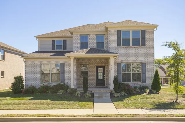 a front view of a house with a yard