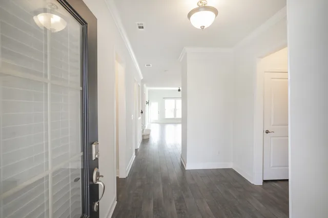 a view of a hallway with wooden floor