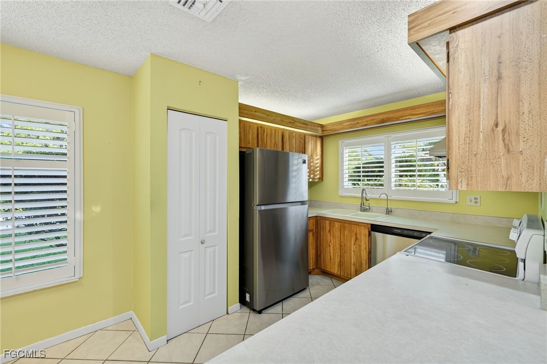 1414 Park Shore Circle, Unit 2 Fort Myers, FL 33901 - Photo 14 of 35 a kitchen with stainless steel appliances granite countertop a refrigerator and a sink