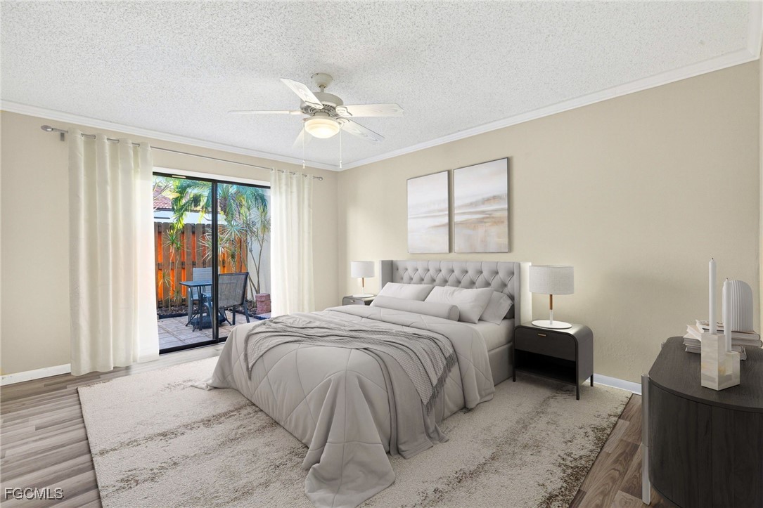 1414 Park Shore Circle, Unit 2 Fort Myers, FL 33901 - Photo 17 of 35 a bedroom with a large bed and a chandelier