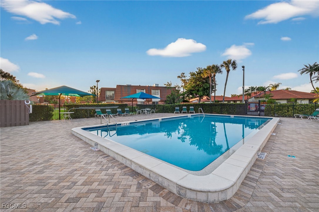 1414 Park Shore Circle, Unit 2 Fort Myers, FL 33901 - Photo 31 of 35 a view of a swimming pool with a yard and plants