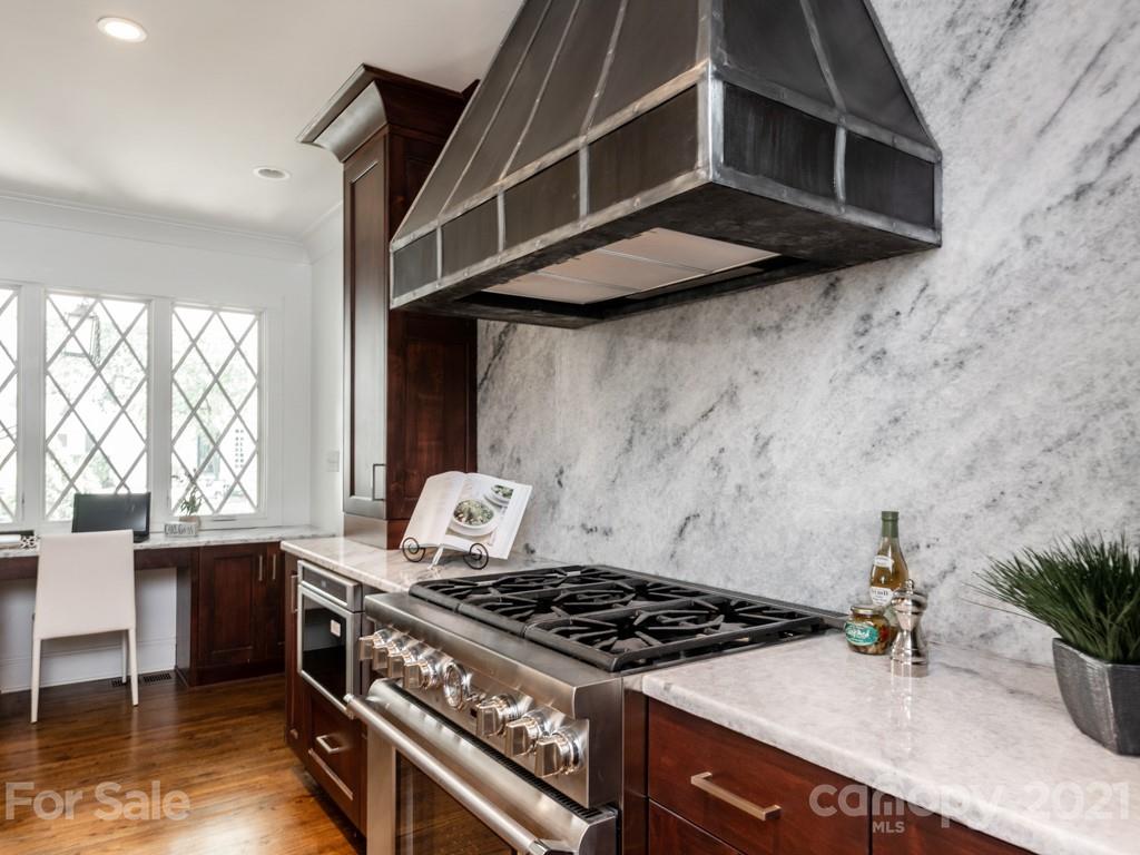 2248 Colony Road Charlotte, NC 28209 - Photo 2 of 27 a kitchen with granite countertop a stove and a white cabinets