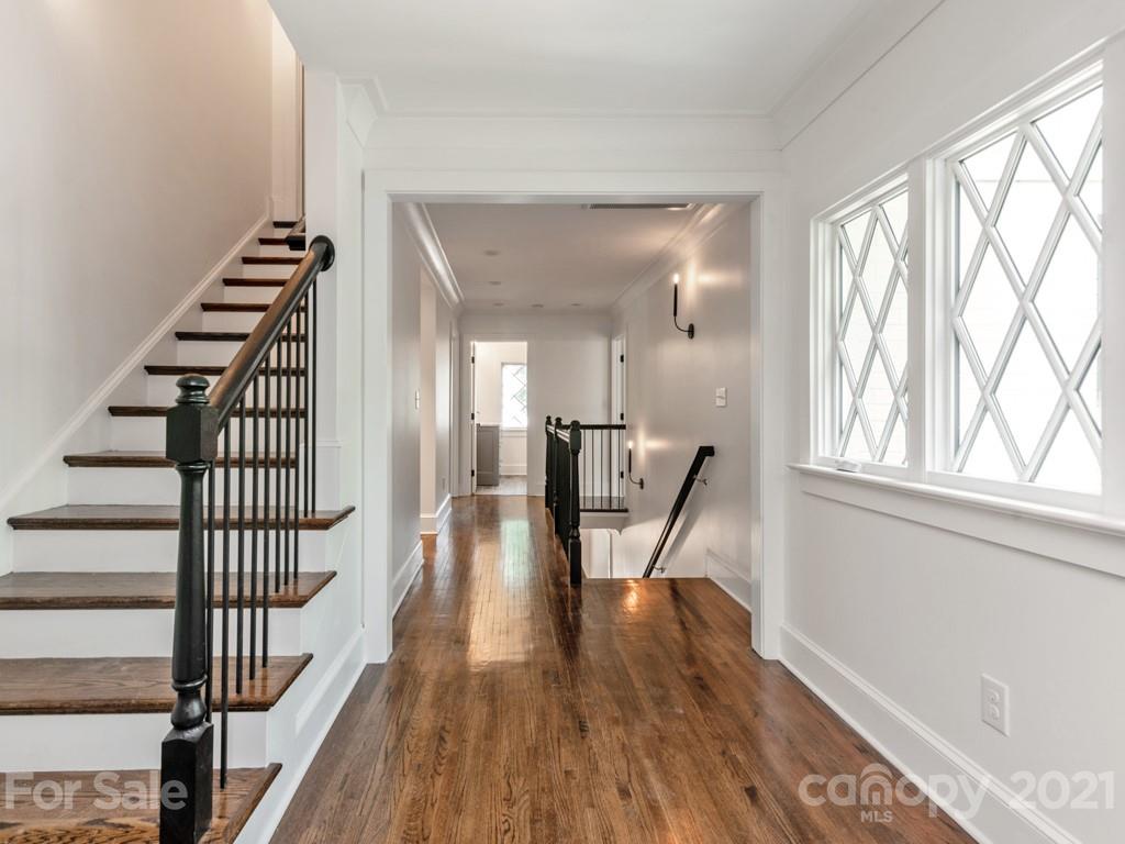 2248 Colony Road Charlotte, NC 28209 - Photo 21 of 27 a view of a hallway with wooden floor and staircase