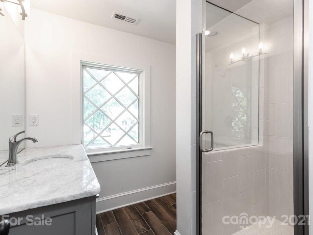 2248 Colony Road Charlotte, NC 28209 - Photo 23 of 27 a bathroom with a sink and a mirror