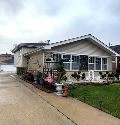 a view of a house with backyard sitting area and porch