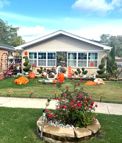 a group of people sitting in front of a house