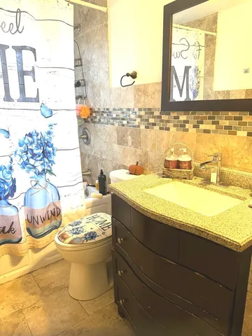 a bedroom with a bed and chandelier