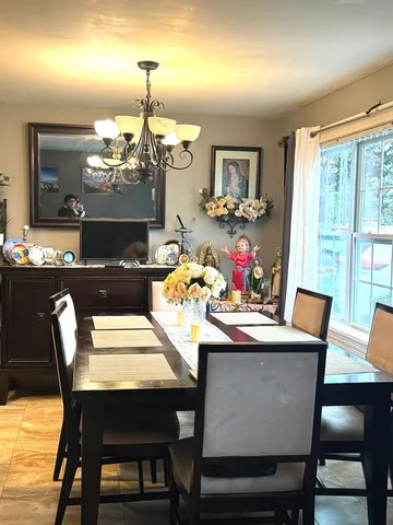 a view of a dining room with furniture window and outside view