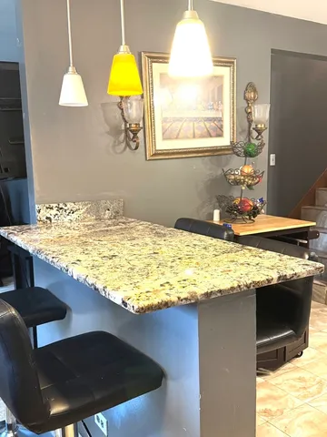 a kitchen with stainless steel appliances granite countertop a sink stove and cabinets