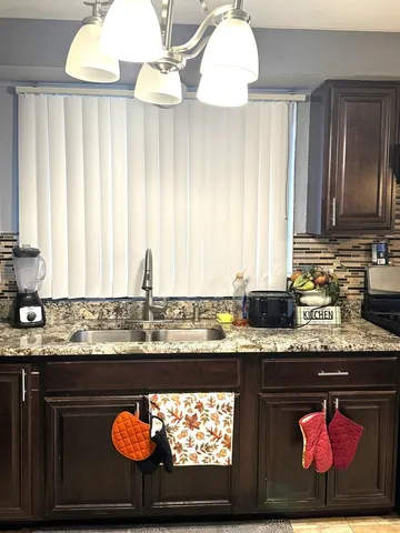 a kitchen with a sink and wooden cabinets