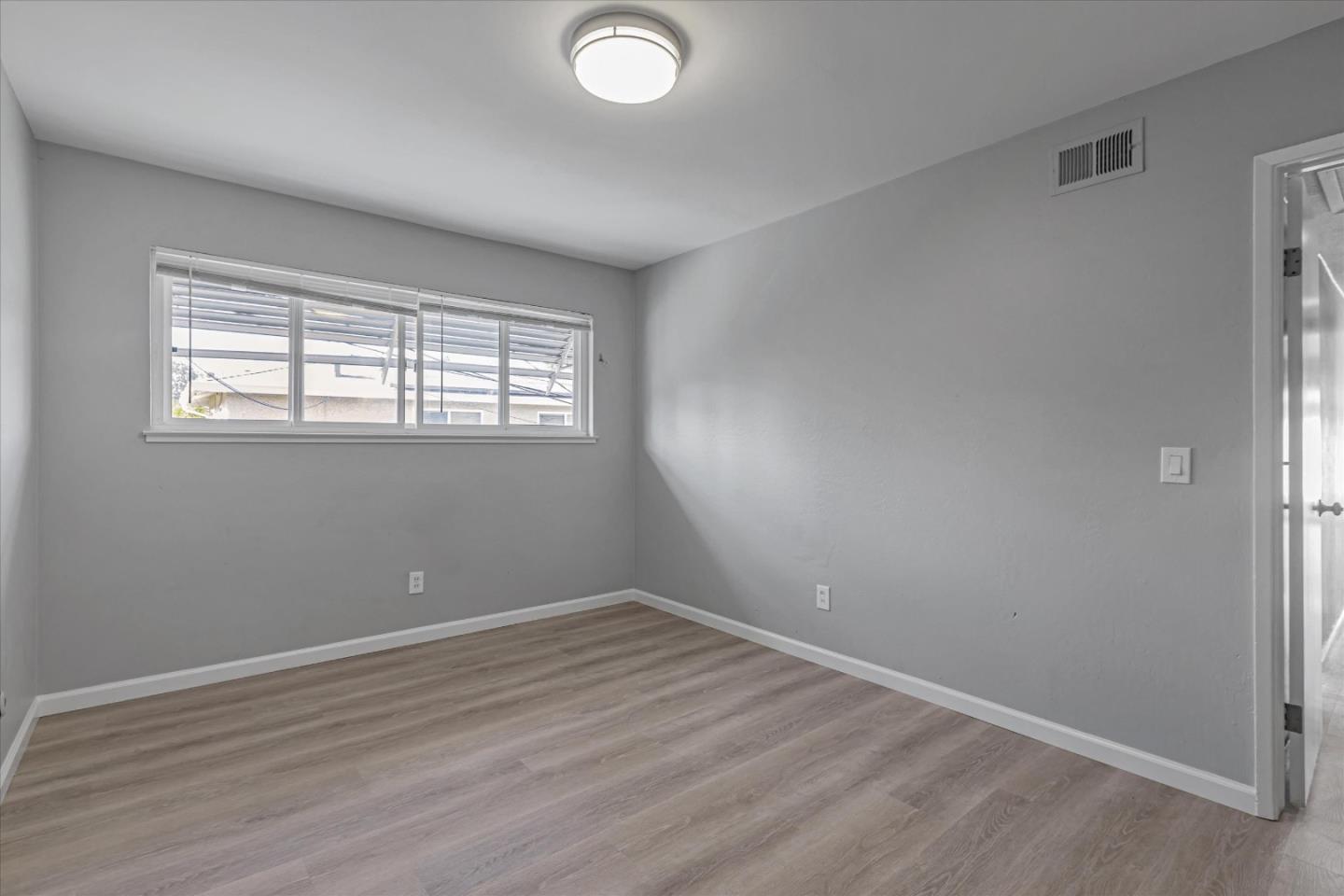 477 Greendale Way San Jose, CA 95129 - Photo 24 of 33 an empty room with wooden floor and windows