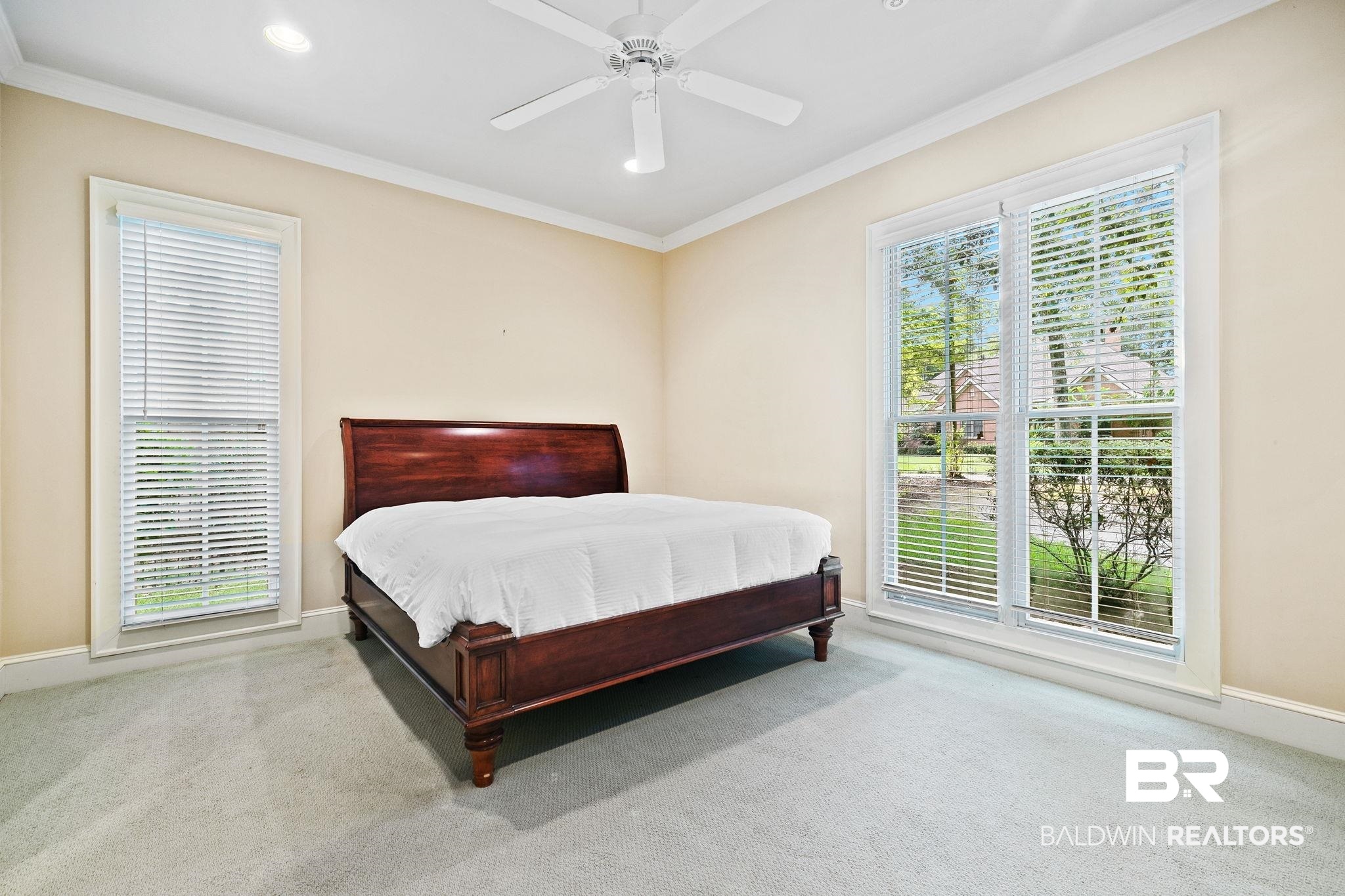 202 Beall Lane Daphne, AL 36526 - Photo 26 of 46 Bedroom featuring multiple windows, carpet flooring, and ceiling fan