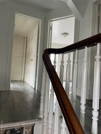 a view of staircase with rug