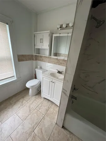 a bathroom with a sink a toilet and vanity