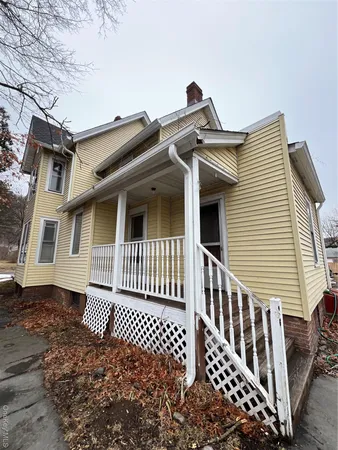 a view of a house with wooden fence