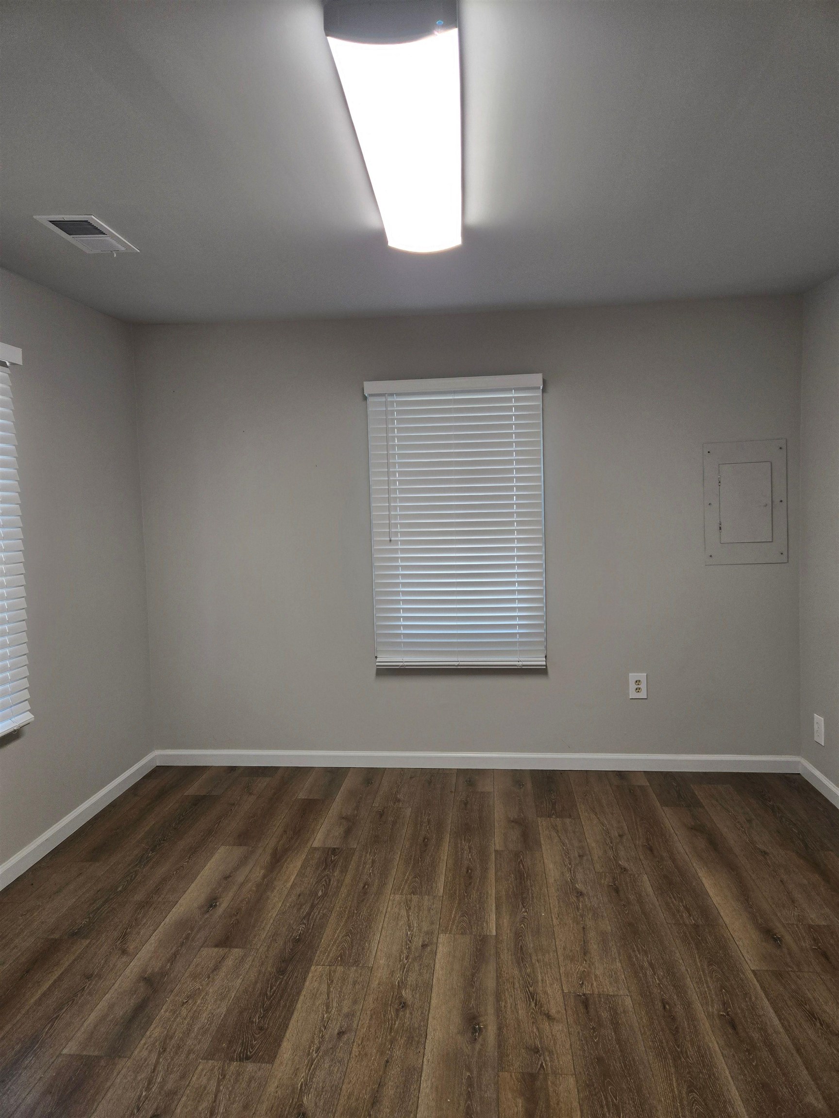6871 Raleigh Lagrange Road Memphis, TN 38134 - Photo 7 of 8 an empty room with wooden floor and windows