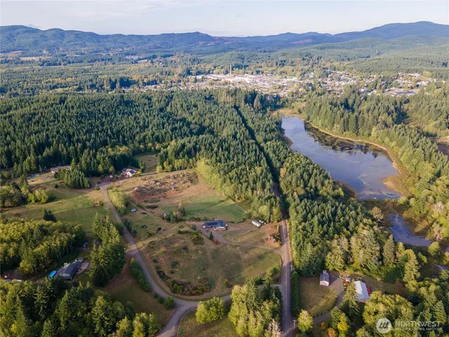 a view of a yard with wooden fence