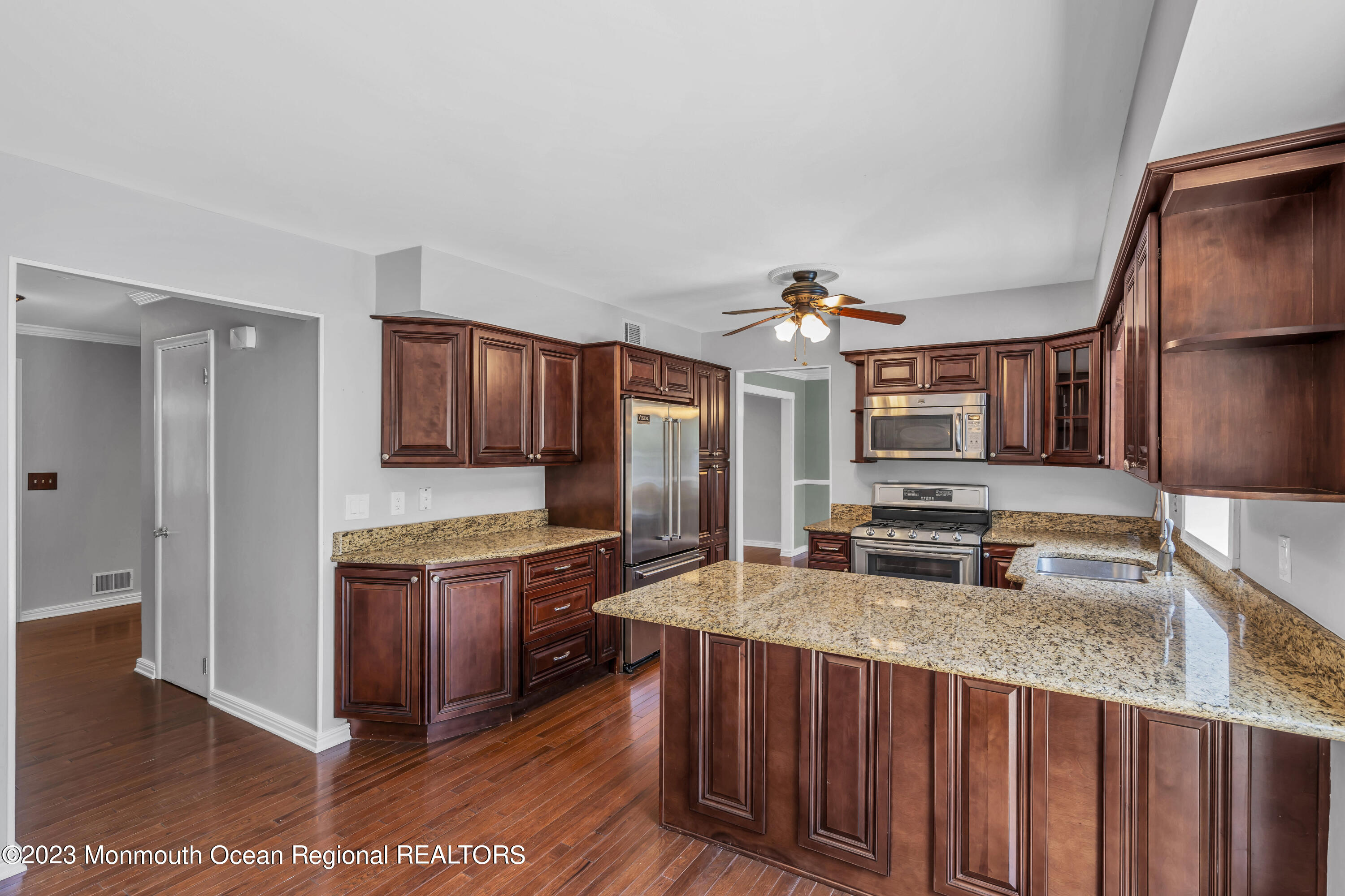 19 Poplar Street Howell, NJ 07731 - Photo 18 of 62 a kitchen with stainless steel appliances granite countertop a sink stove and refrigerator