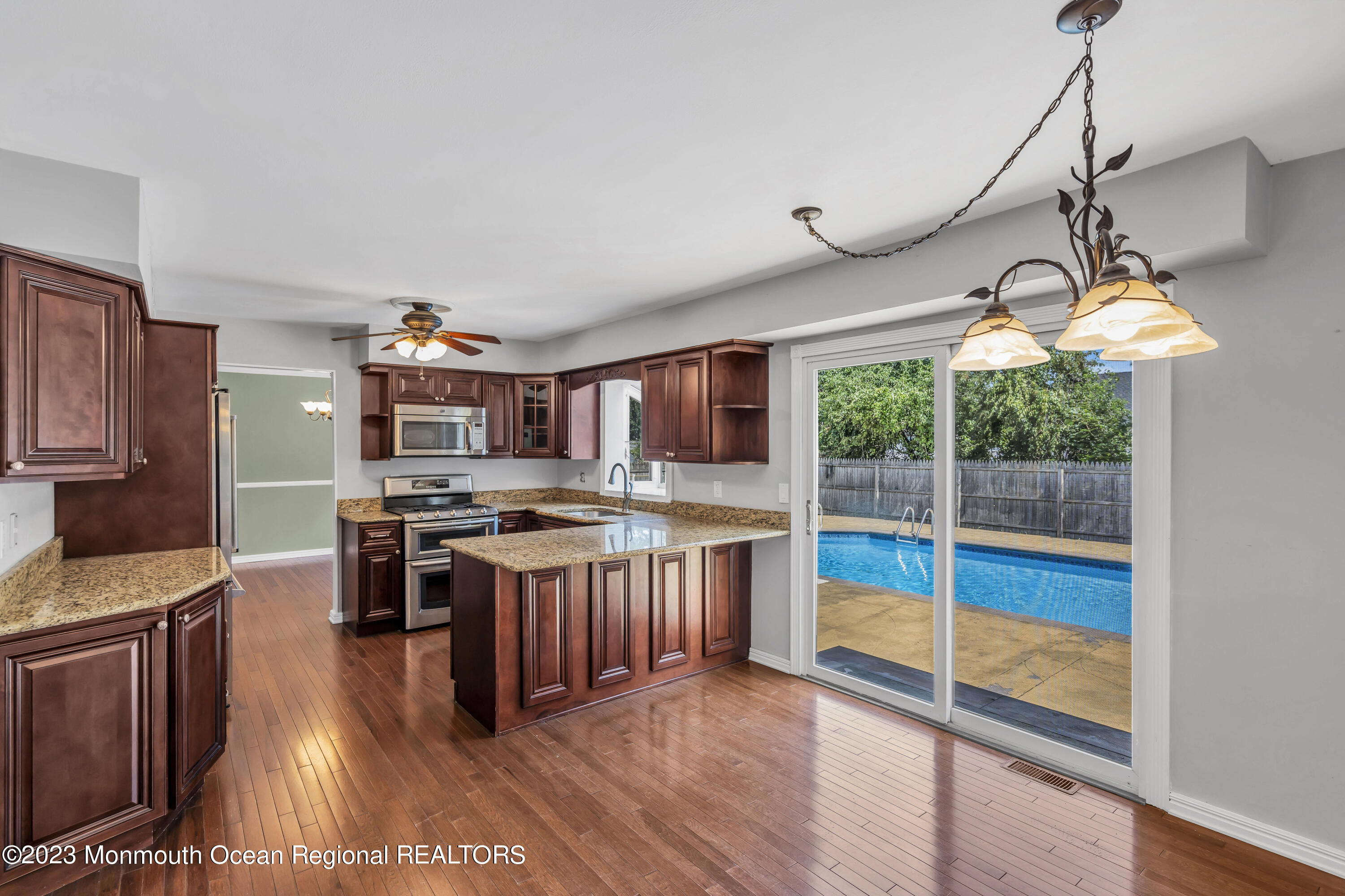 19 Poplar Street Howell, NJ 07731 - Photo 25 of 62 a kitchen with stainless steel appliances granite countertop a stove and a sink