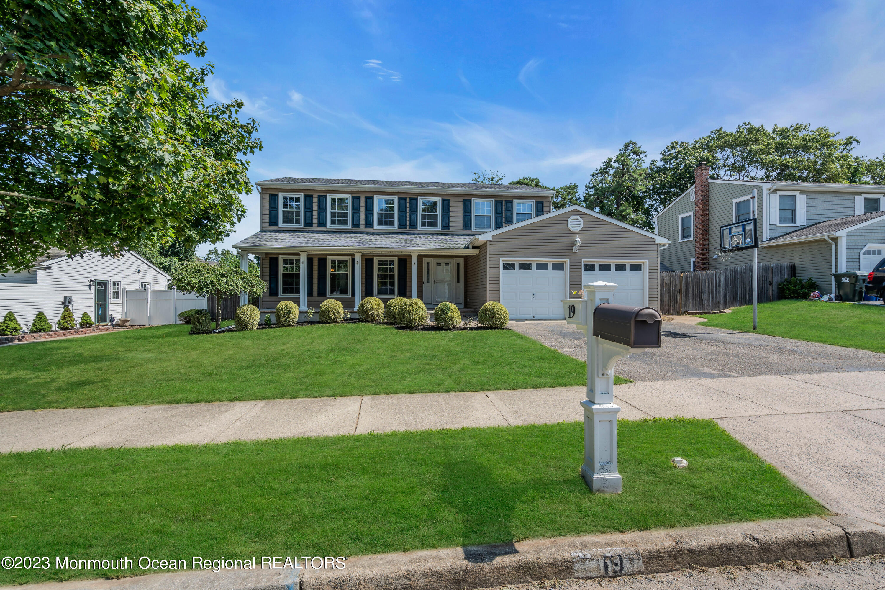 19 Poplar Street Howell, NJ 07731 - Photo 3 of 62 a front view of a house with a garden