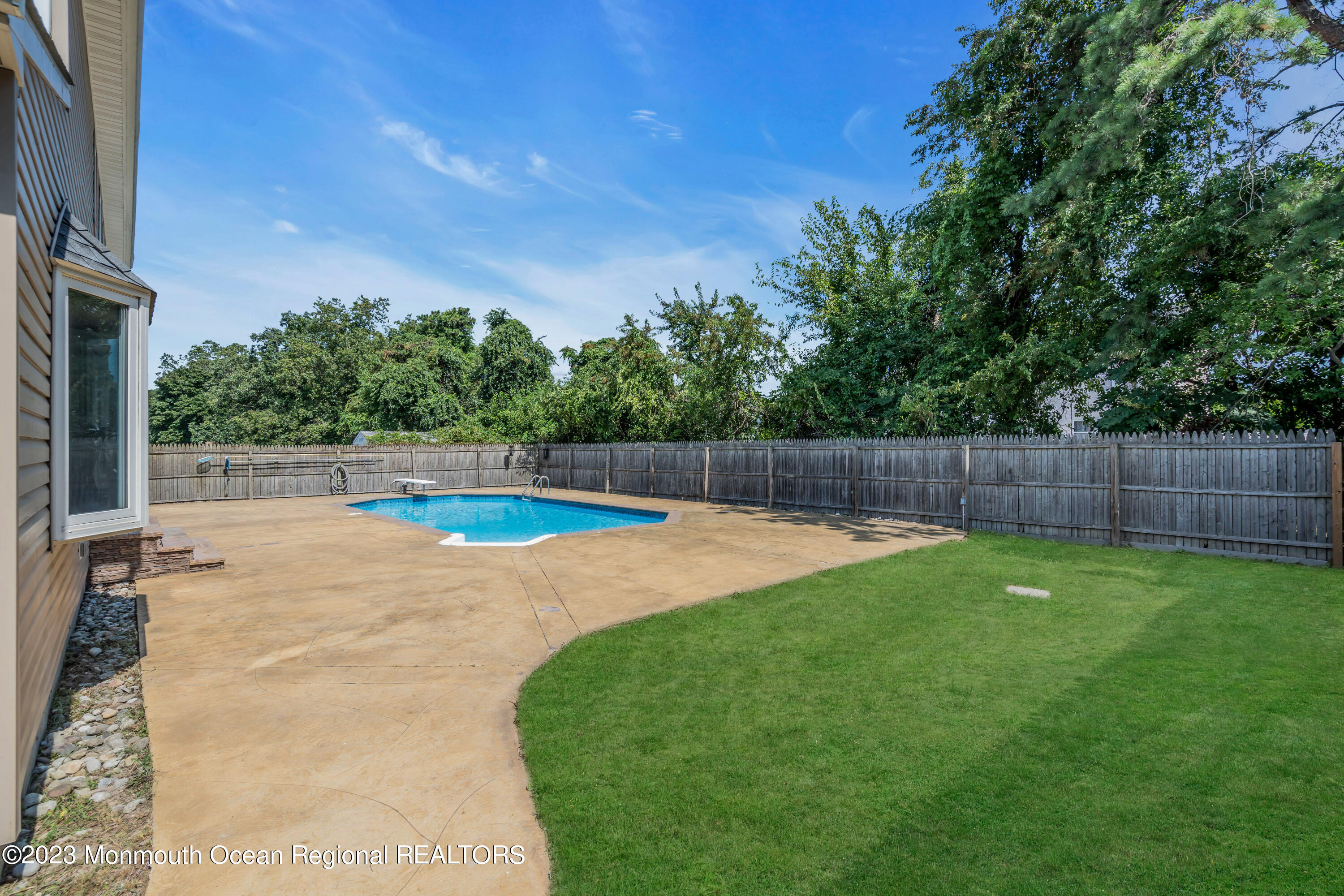19 Poplar Street Howell, NJ 07731 - Photo 60 of 62 a view of a backyard with swimming pool and seating