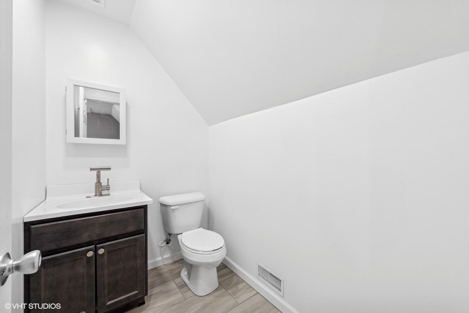 1025 Wallace Street Gary, IN 46404 - Photo 13 of 19 a bathroom with a sink toilet and vanity