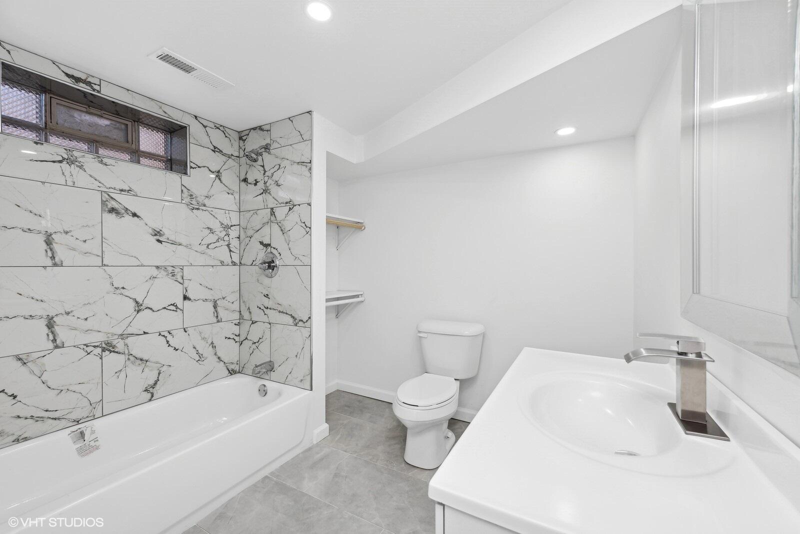 1025 Wallace Street Gary, IN 46404 - Photo 15 of 19 a bathroom with a sink a toilet and bathtub