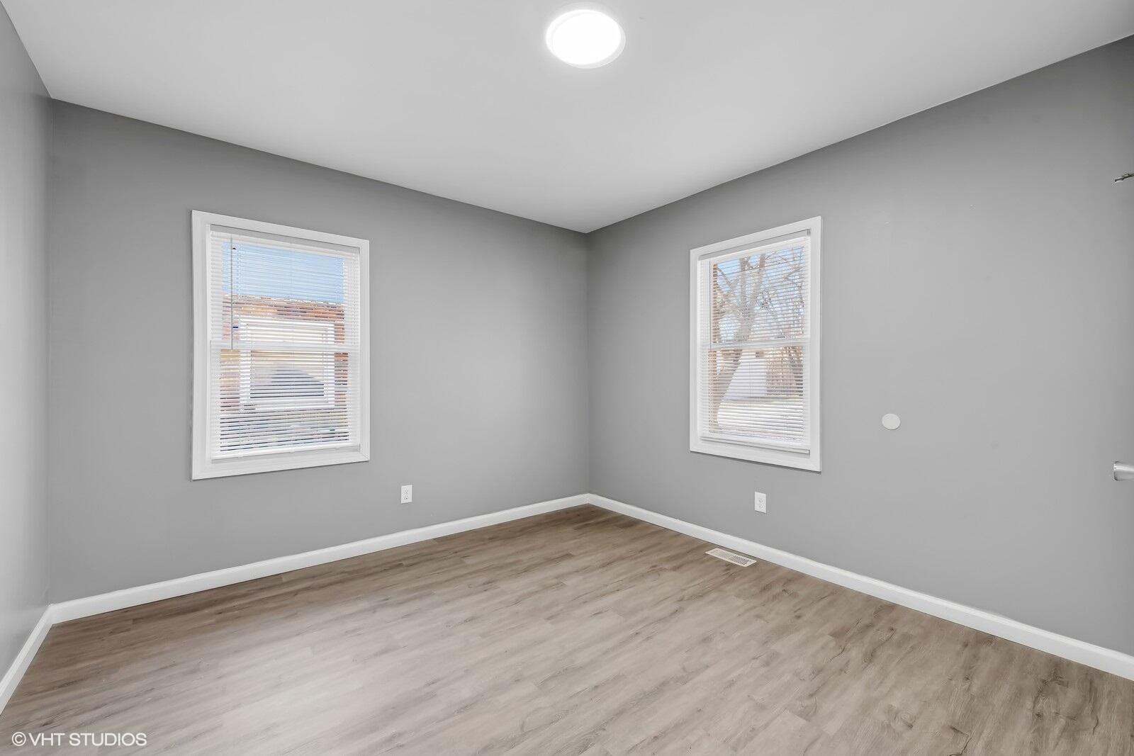 1025 Wallace Street Gary, IN 46404 - Photo 6 of 19 a view of an empty room with wooden floor and a window