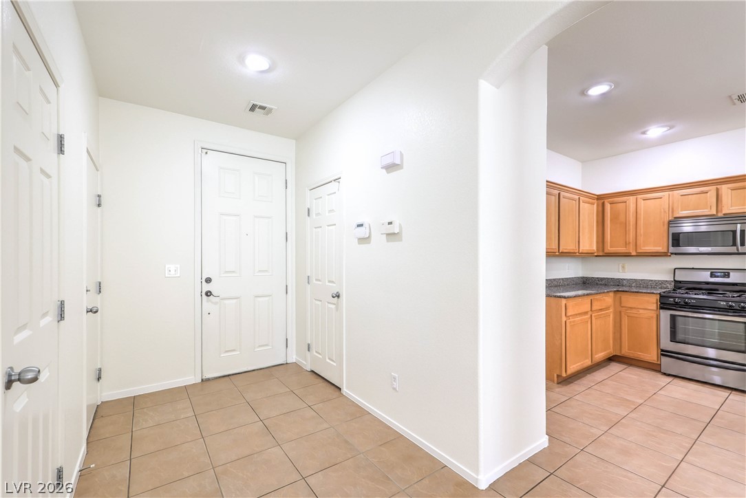 10939 Paradise Road Henderson, NV 89052 - Photo 5 of 36 A welcoming entry foyer transitions seamlessly to a well-appointed kitchen, ideal for daily living.
